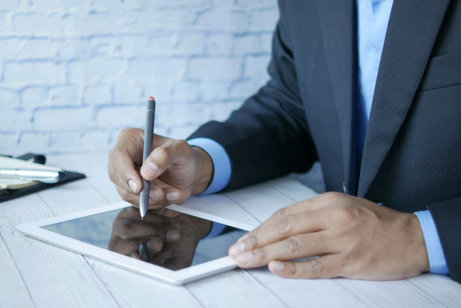 Managing agent reviewing building paperwork on a tablet